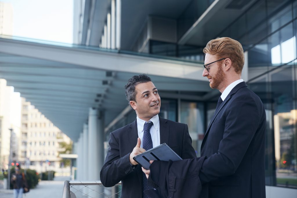 business people working outside office building scaled